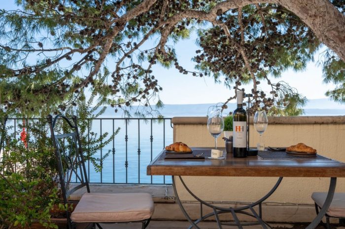 Mediterranean breakfast on the outdoor terrace with a bottle of wine